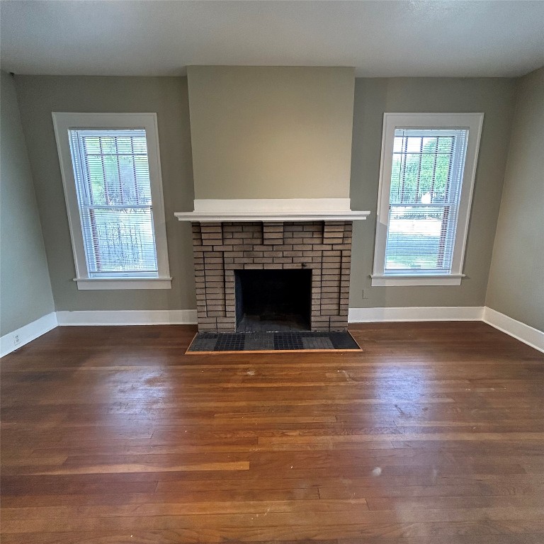 1115 West 22 1/2 Street Austin, TX 78705 - Photo 6 of 33 an empty room with wooden floor fireplace and windows