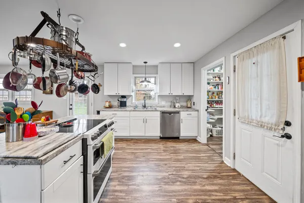 a kitchen with stainless steel appliances granite countertop a sink and cabinets