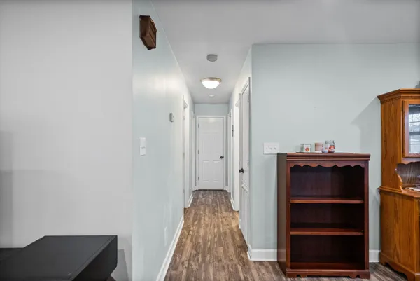 a view of hallway with stairs and wooden floor