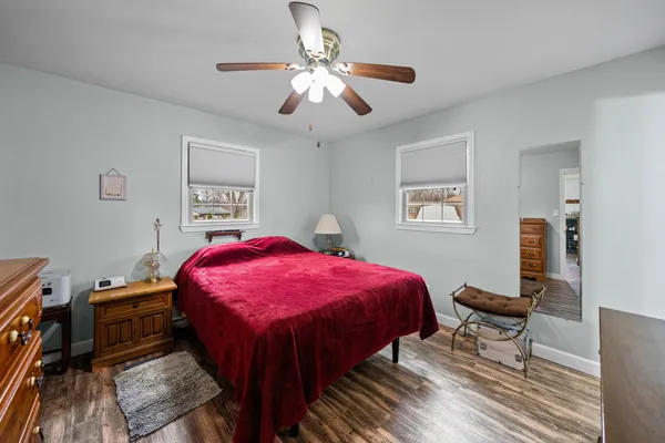 a spacious bedroom with a bed and a chandelier