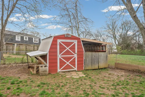 a view of a backyard with a table and chairs