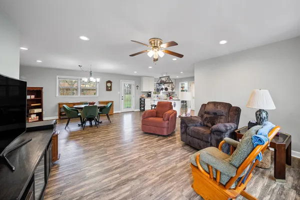 a living room with furniture and wooden floor