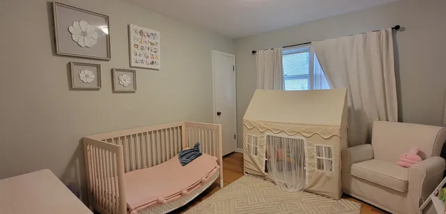 a bedroom with furniture and a window