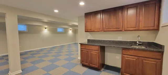 a kitchen with granite countertop a sink and a stove