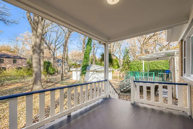a view of a porch with a floor to ceiling window and wooden floor