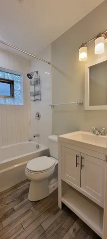 a bathroom with a sink toilet a mirror and bathtub