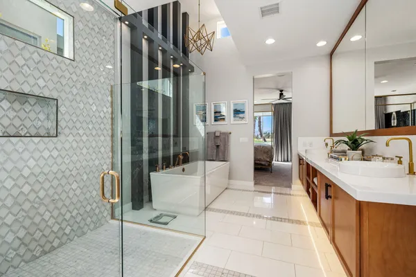 a large bathroom with a granite countertop sink a toilet a mirror and shower