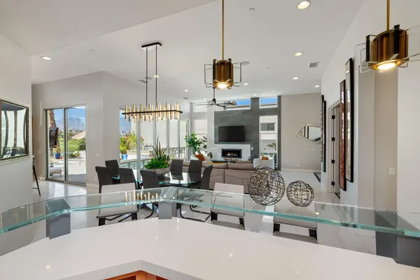 a living room with furniture a flat screen tv and a large window