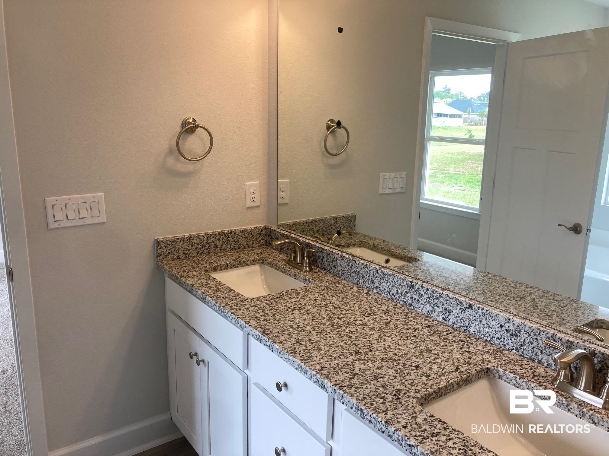 705 Mayflower Drive Foley, AL 36535 - Photo 12 of 19 Full bath featuring double vanity, a sink, and baseboards