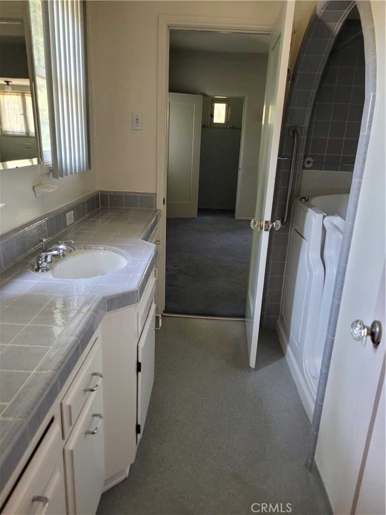 655 Westgate Street Pasadena, CA 91103 - Photo 11 of 20 a bathroom with a sink and a mirror