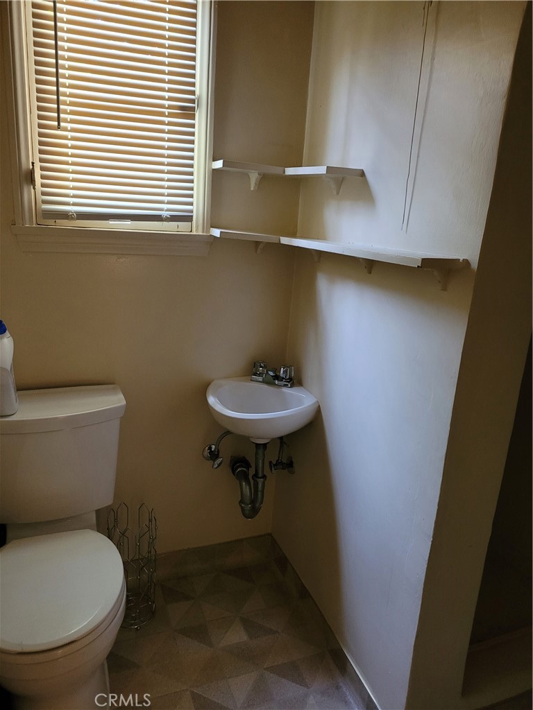 655 Westgate Street Pasadena, CA 91103 - Photo 12 of 20 a bathroom with a sink a toilet and a window