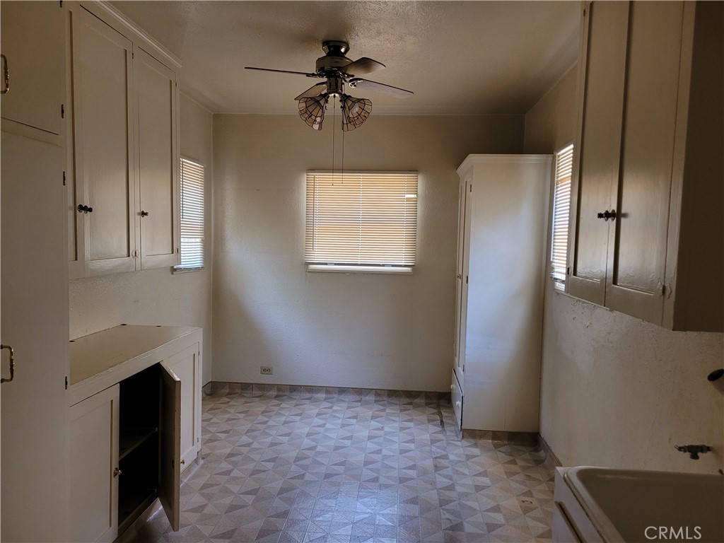 655 Westgate Street Pasadena, CA 91103 - Photo 14 of 20 an empty room with windows cabinet and fireplace