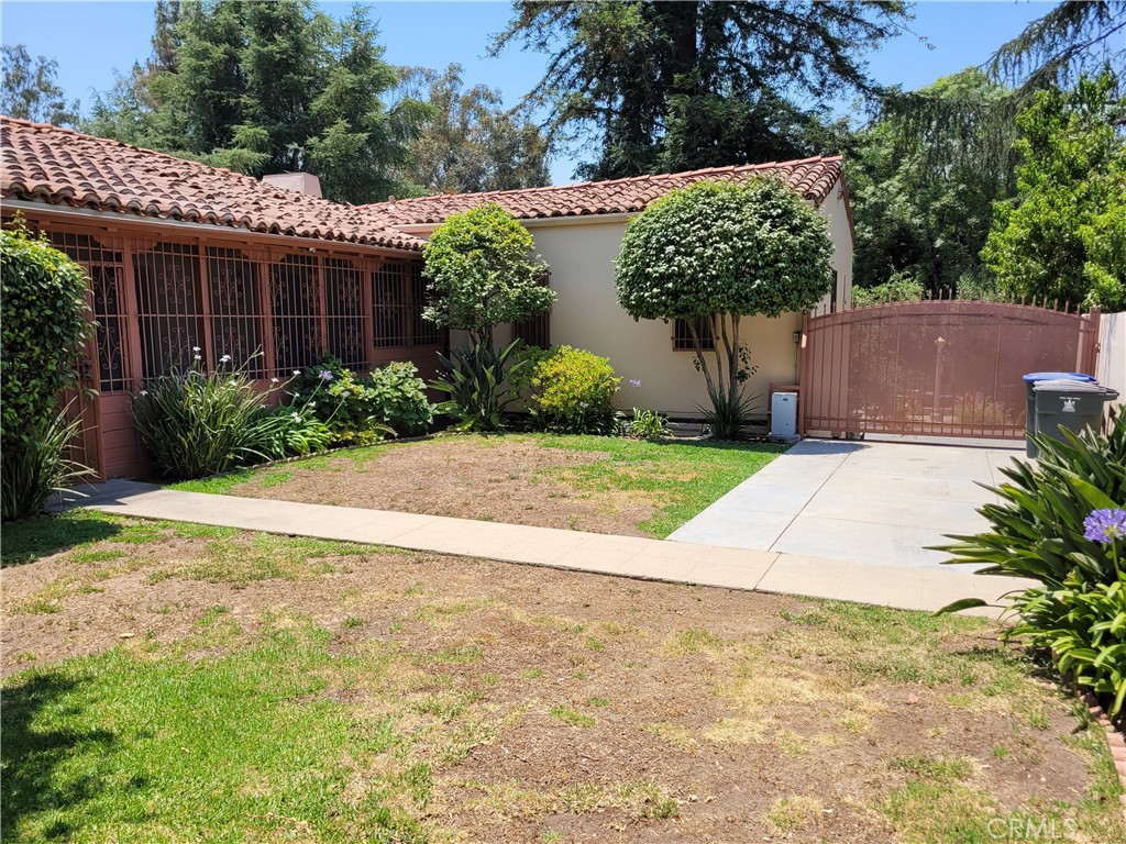 655 Westgate Street Pasadena, CA 91103 - Photo 17 of 20 a front view of a house with a yard and a garden
