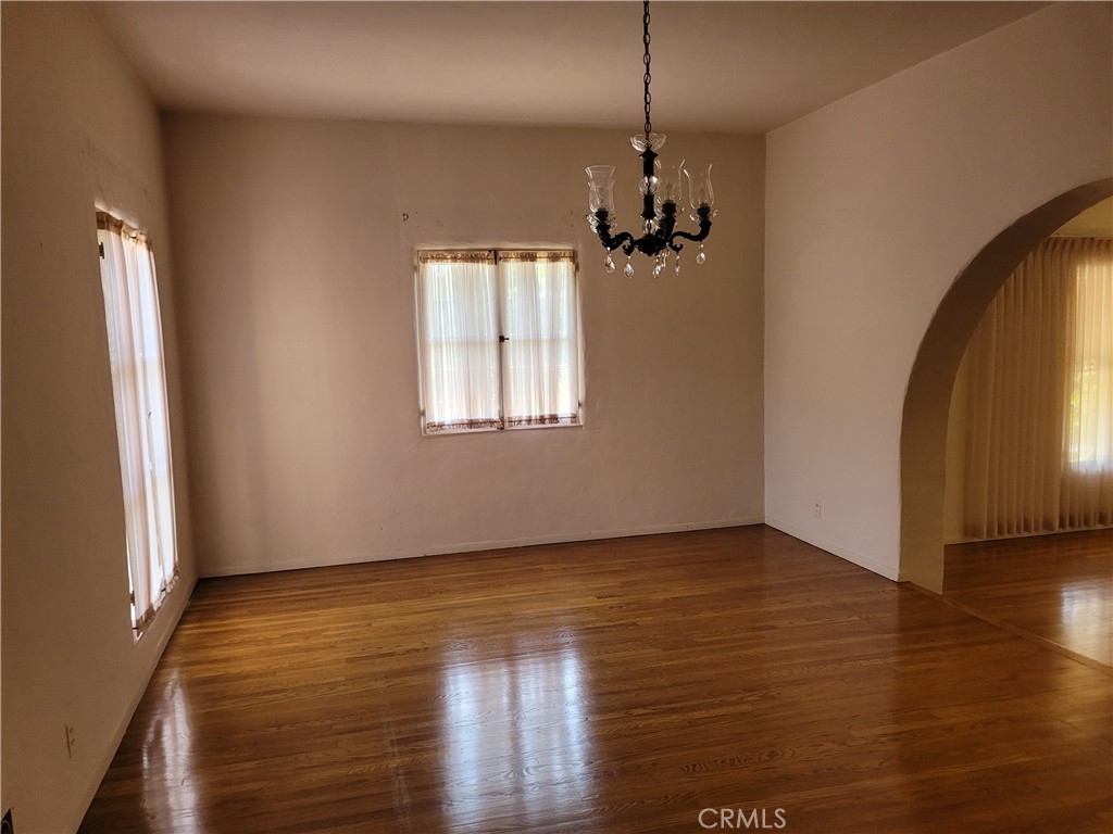 655 Westgate Street Pasadena, CA 91103 - Photo 5 of 20 an empty room with wooden floor windows and entrance