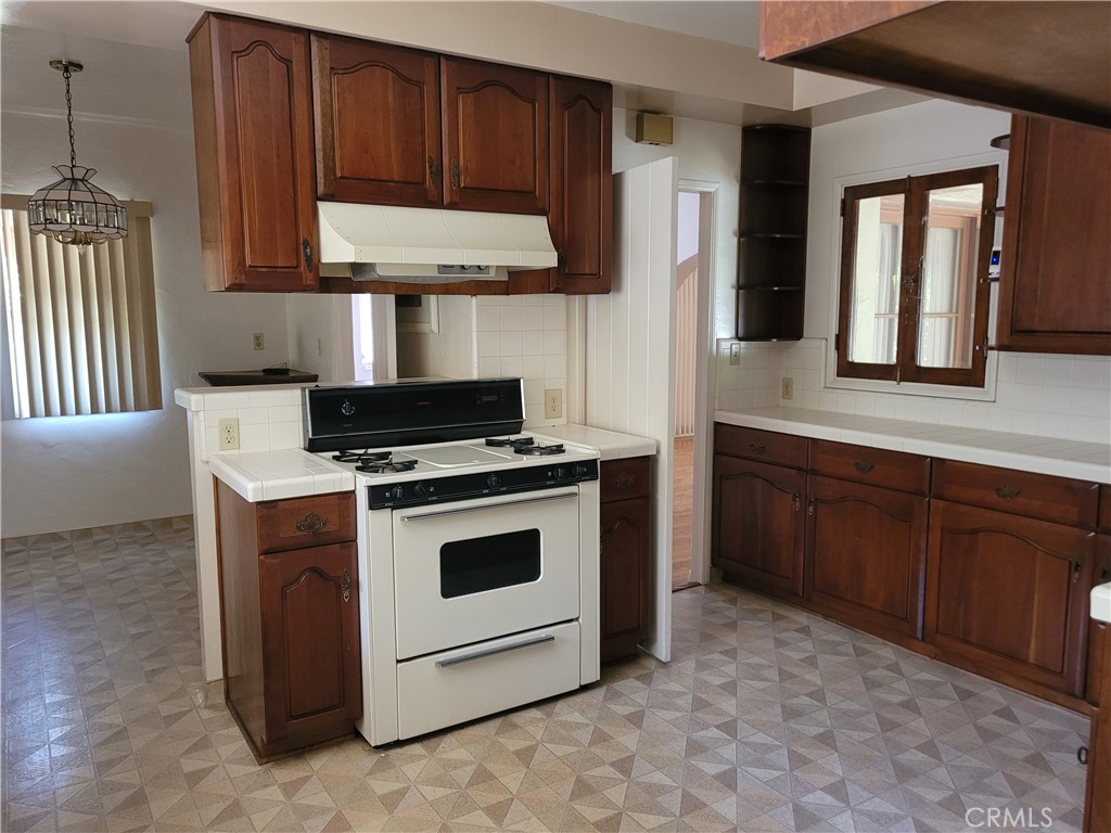 655 Westgate Street Pasadena, CA 91103 - Photo 6 of 20 a kitchen with stainless steel appliances granite countertop a stove a microwave and a refrigerator