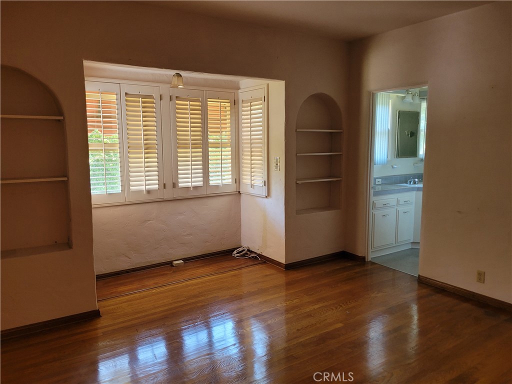 655 Westgate Street Pasadena, CA 91103 - Photo 7 of 20 an empty room with wooden floor and windows