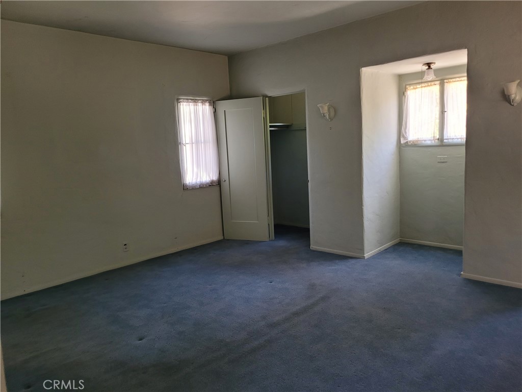 655 Westgate Street Pasadena, CA 91103 - Photo 9 of 20 an empty room with windows and closet