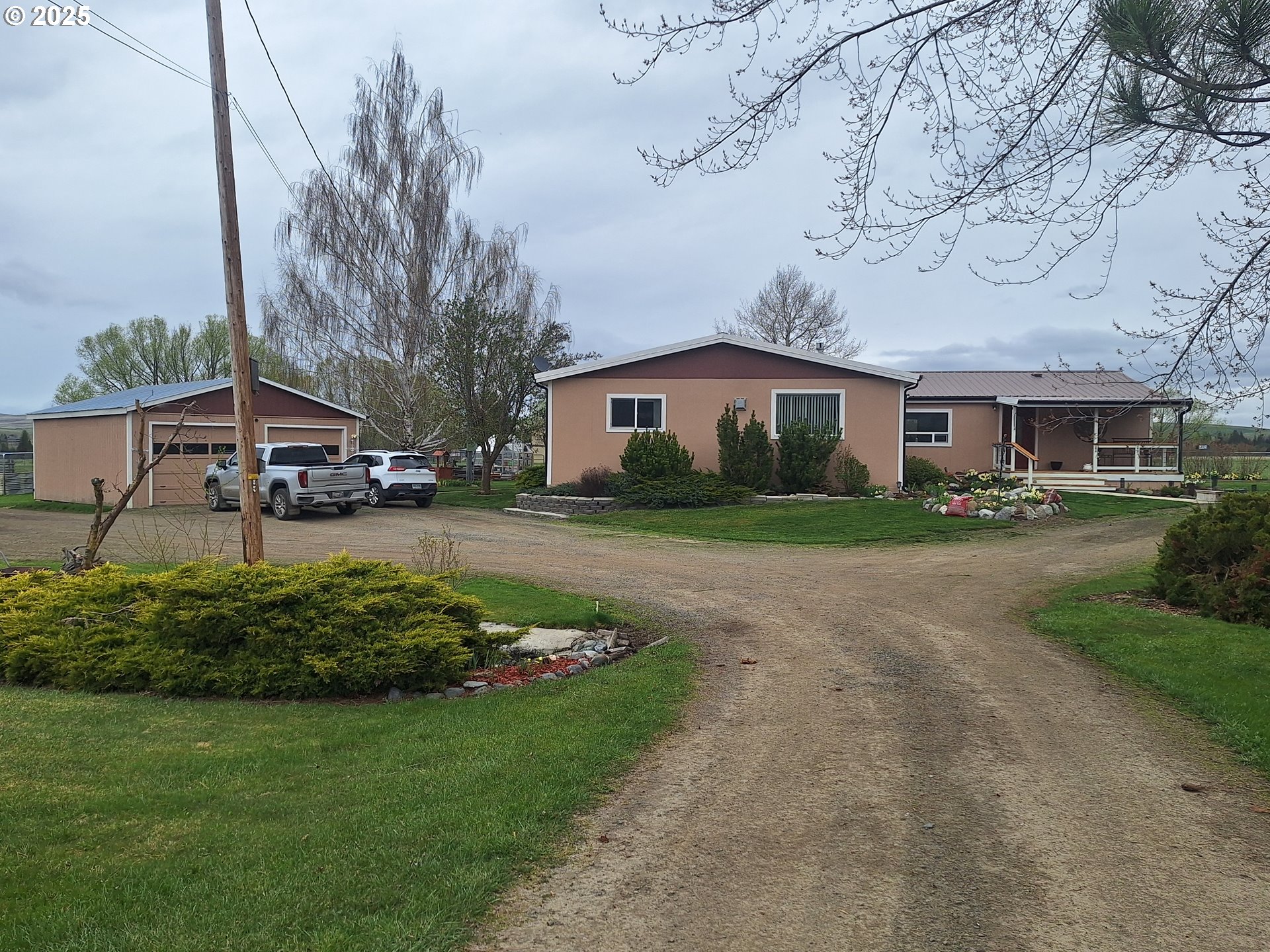 64929 Hurricane Creek Road Enterprise, OR 97828 - Photo 14 of 22 a front view of a house with a garden and trees