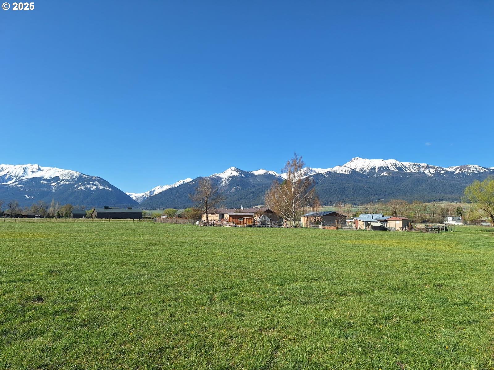 64929 Hurricane Creek Road Enterprise, OR 97828 - Photo 20 of 22 a view of a lush green hillside and houses