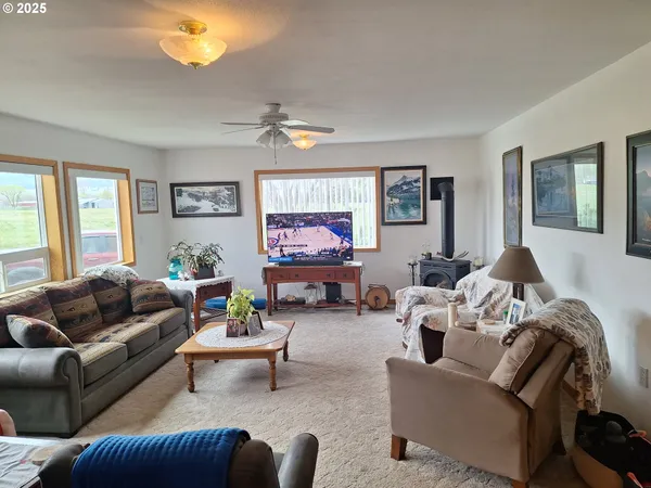 a living room with furniture a chandelier and a window