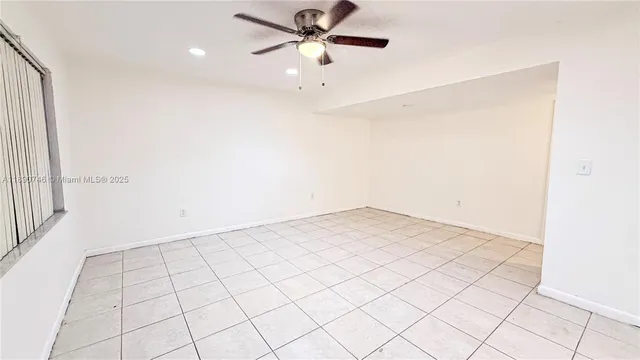 a view of a room with window and a ceiling fan