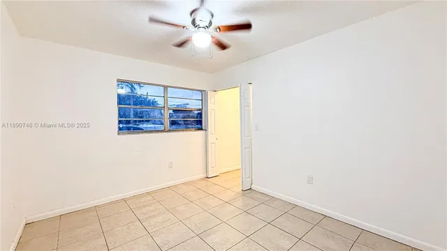 a view of a livingroom with a ceiling fan and window