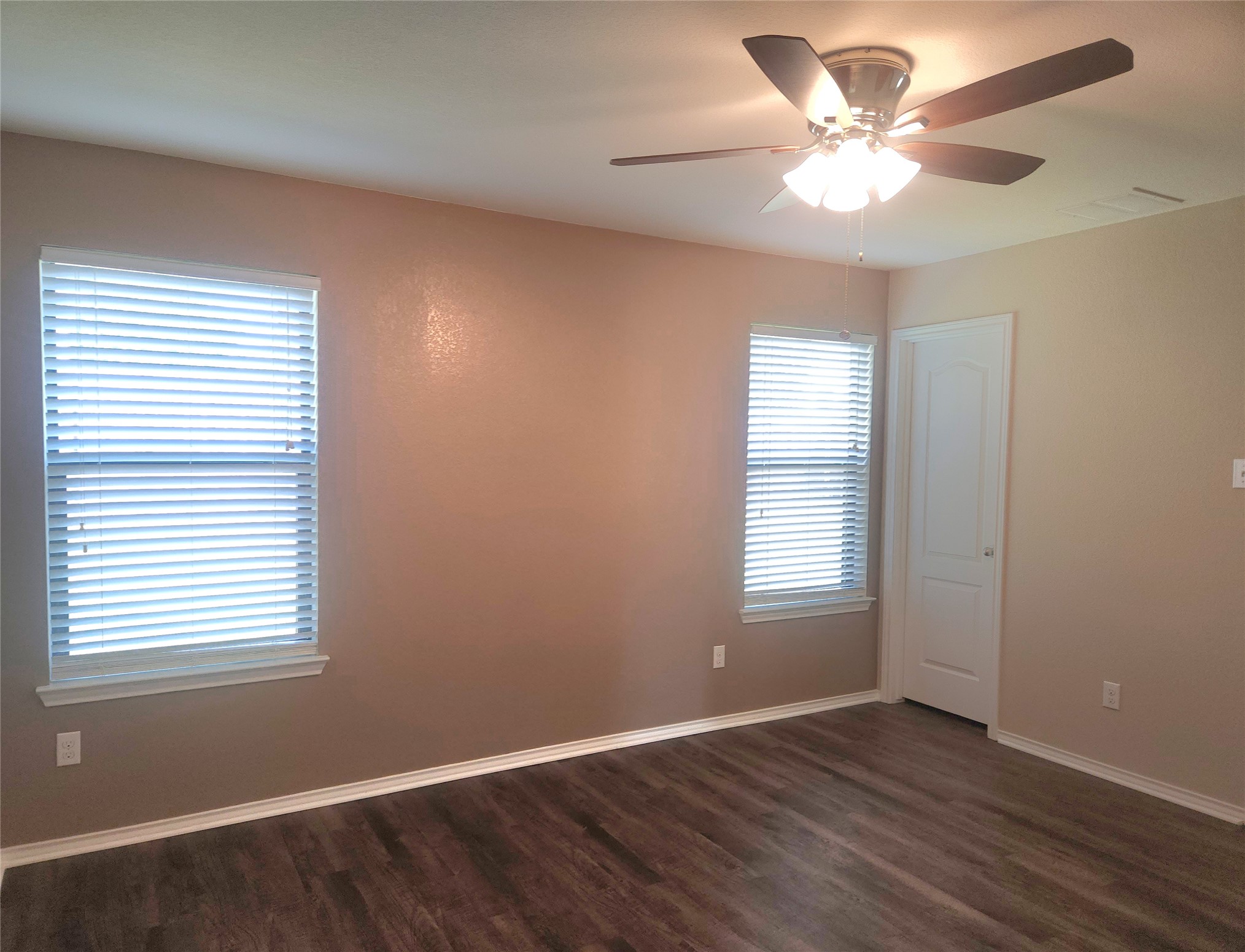 160 Rummel Drive Kyle, TX 78640 - Photo 5 of 13 A well-lit bedroom featuring handsome wood flooring and a refreshing ceiling fan.