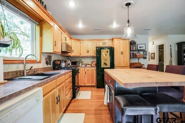 a kitchen with stainless steel appliances granite countertop sink refrigerator and microwave