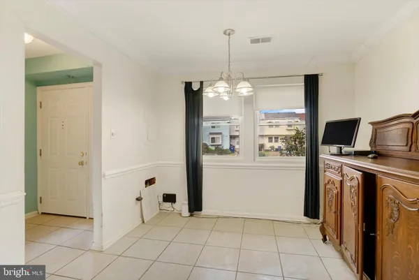 a view of a kitchen with a refrigerator a sink and dishwasher with wooden floor