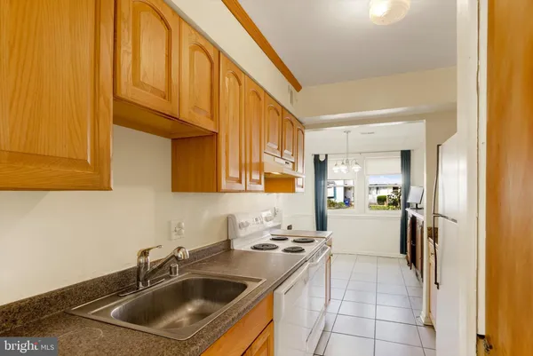 a kitchen with a sink cabinets and entryway