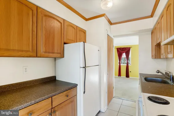 a kitchen with a refrigerator a stove and a cabinets