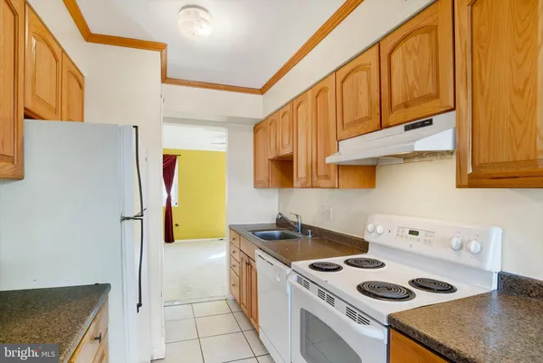 a kitchen with a stove a refrigerator and a sink