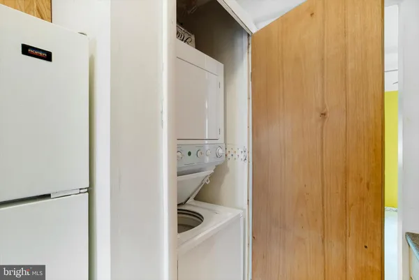 a room with a sink and washing machine
