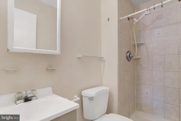 a bathroom with a toilet sink and shower