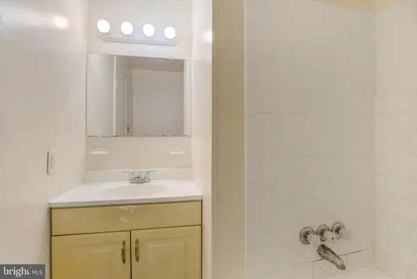 a bathroom with a sink vanity and a mirror