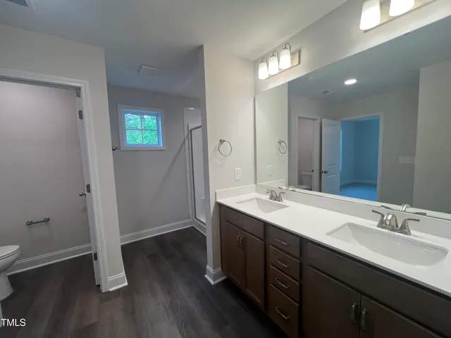 a bathroom with a double vanity sink and mirror