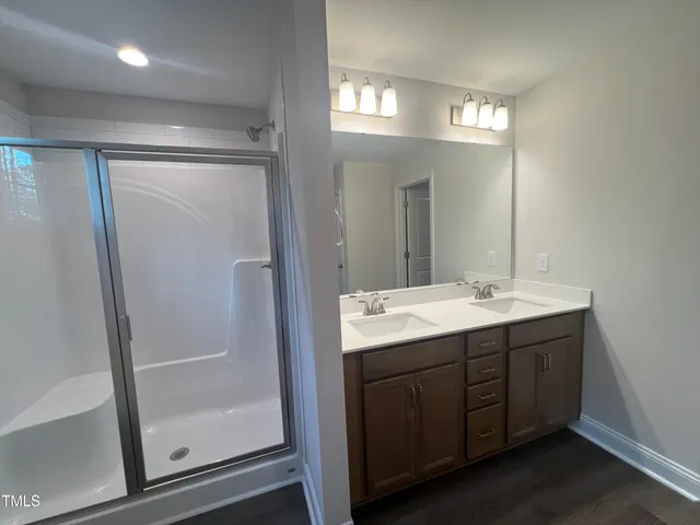 a bathroom with a double vanity sink and mirror