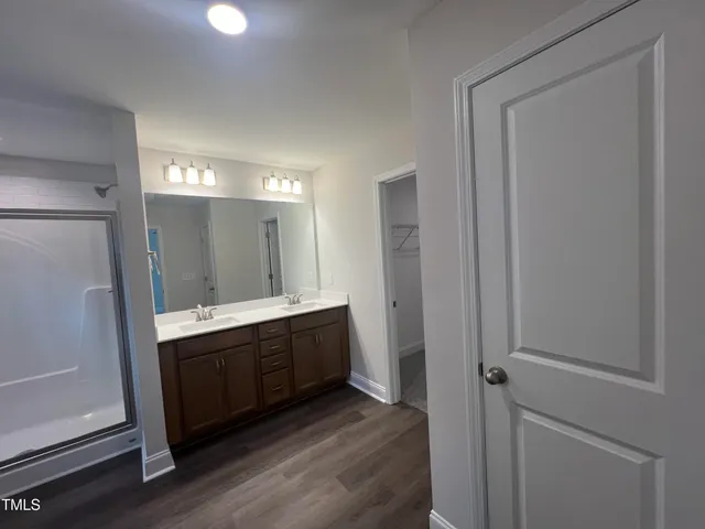 a bathroom with a double vanity sink a and mirror