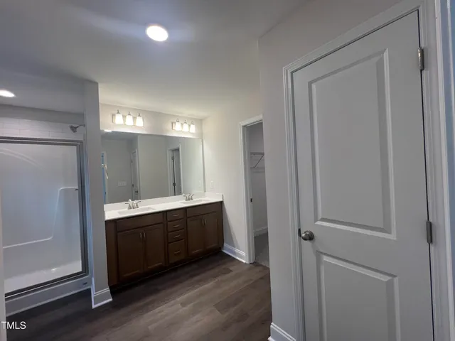 a view of an empty room with a chandelier fan
