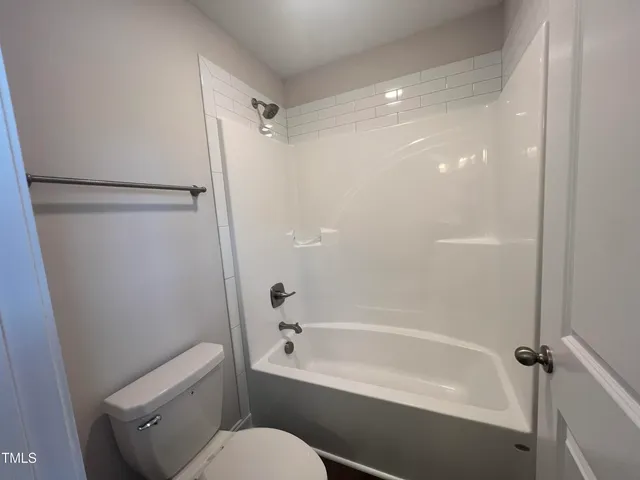 a view of a room with wooden floor and fan