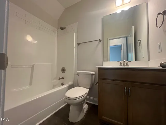 a large kitchen with cabinets a sink dishwasher a stove and a refrigerator with wooden floor