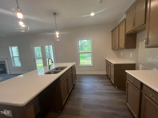 a view of a kitchen with a sink and a stove top oven
