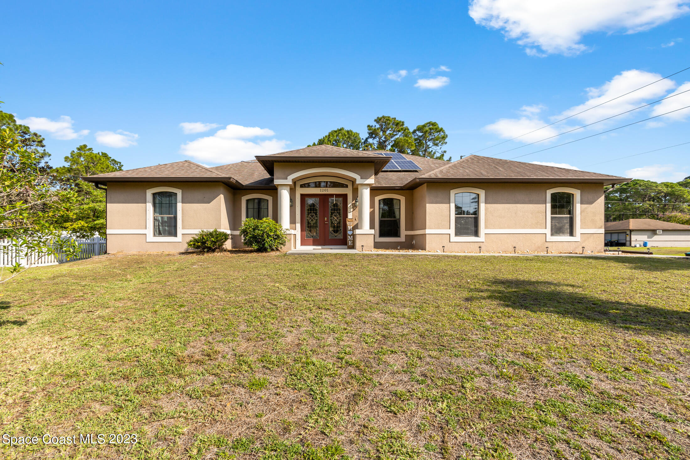 1201 Daton Road Southwest Palm Bay, FL 32908 - Photo 1 of 46 a front view of a house with a garden