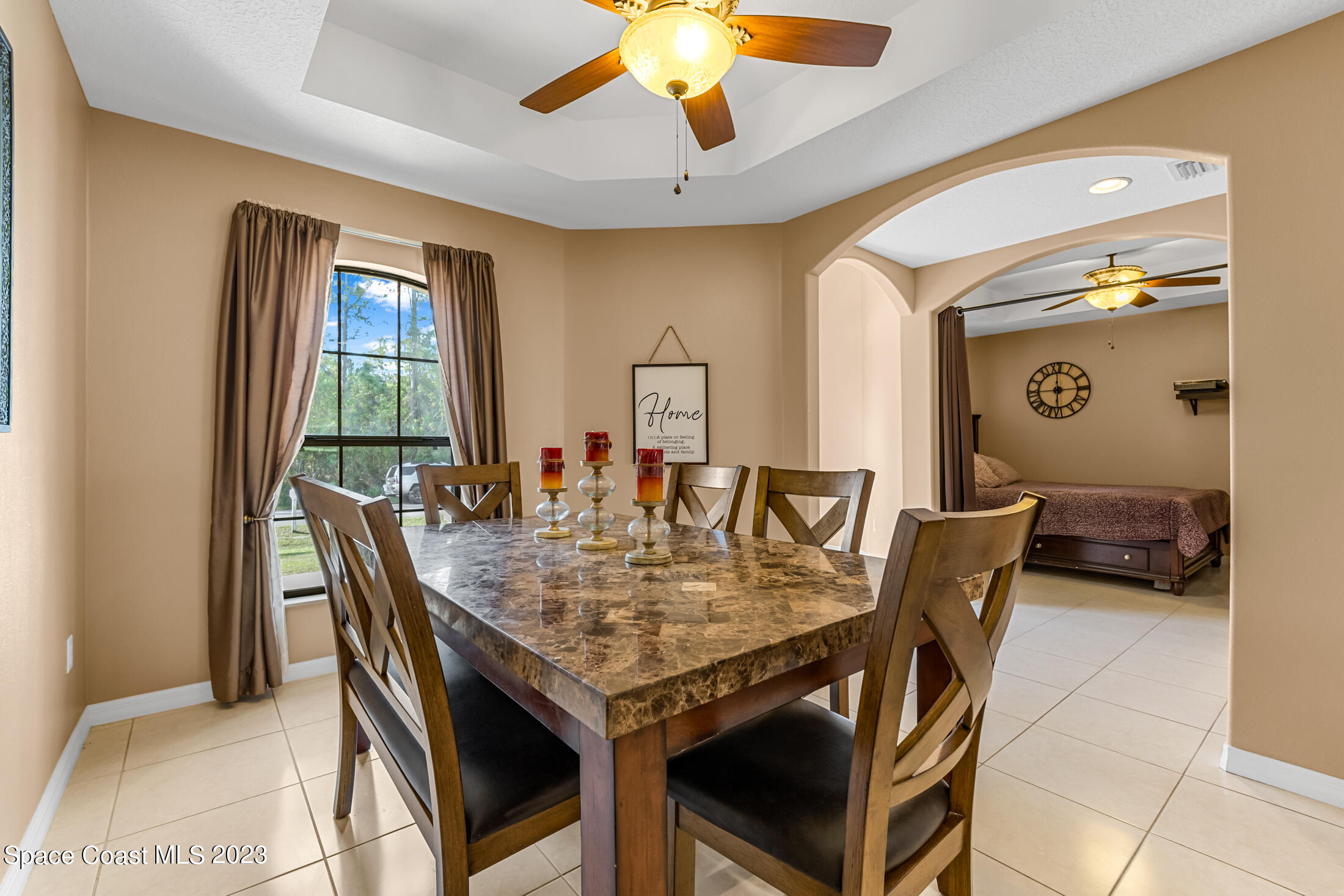1201 Daton Road Southwest Palm Bay, FL 32908 - Photo 16 of 46 a view of a dining room with furniture and a chandelier