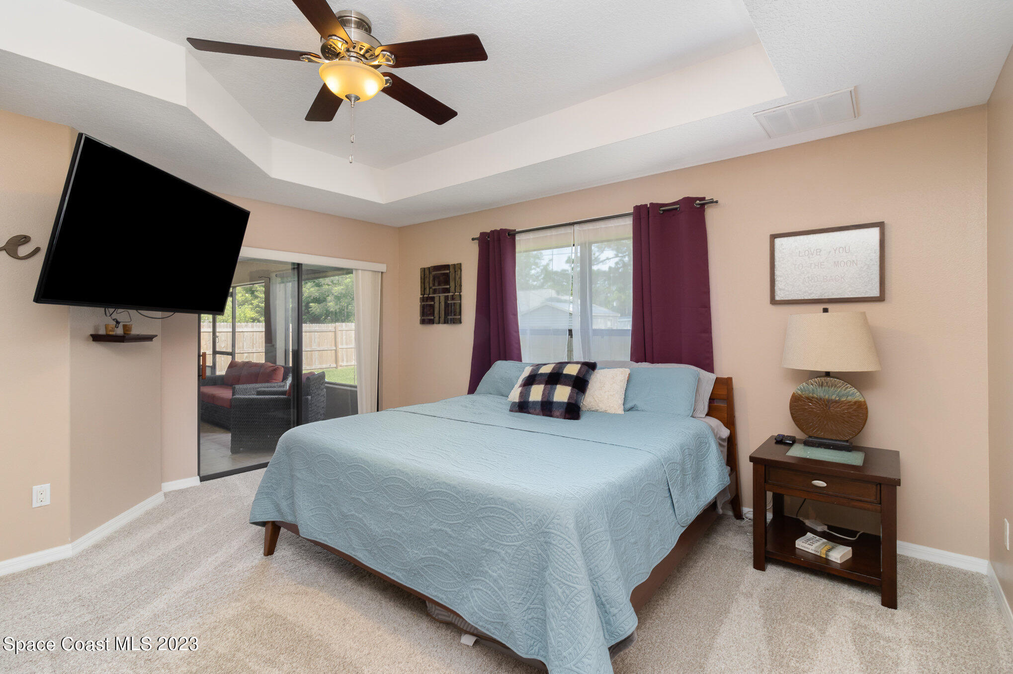 1201 Daton Road Southwest Palm Bay, FL 32908 - Photo 21 of 46 a bedroom with a bed and a flat screen tv