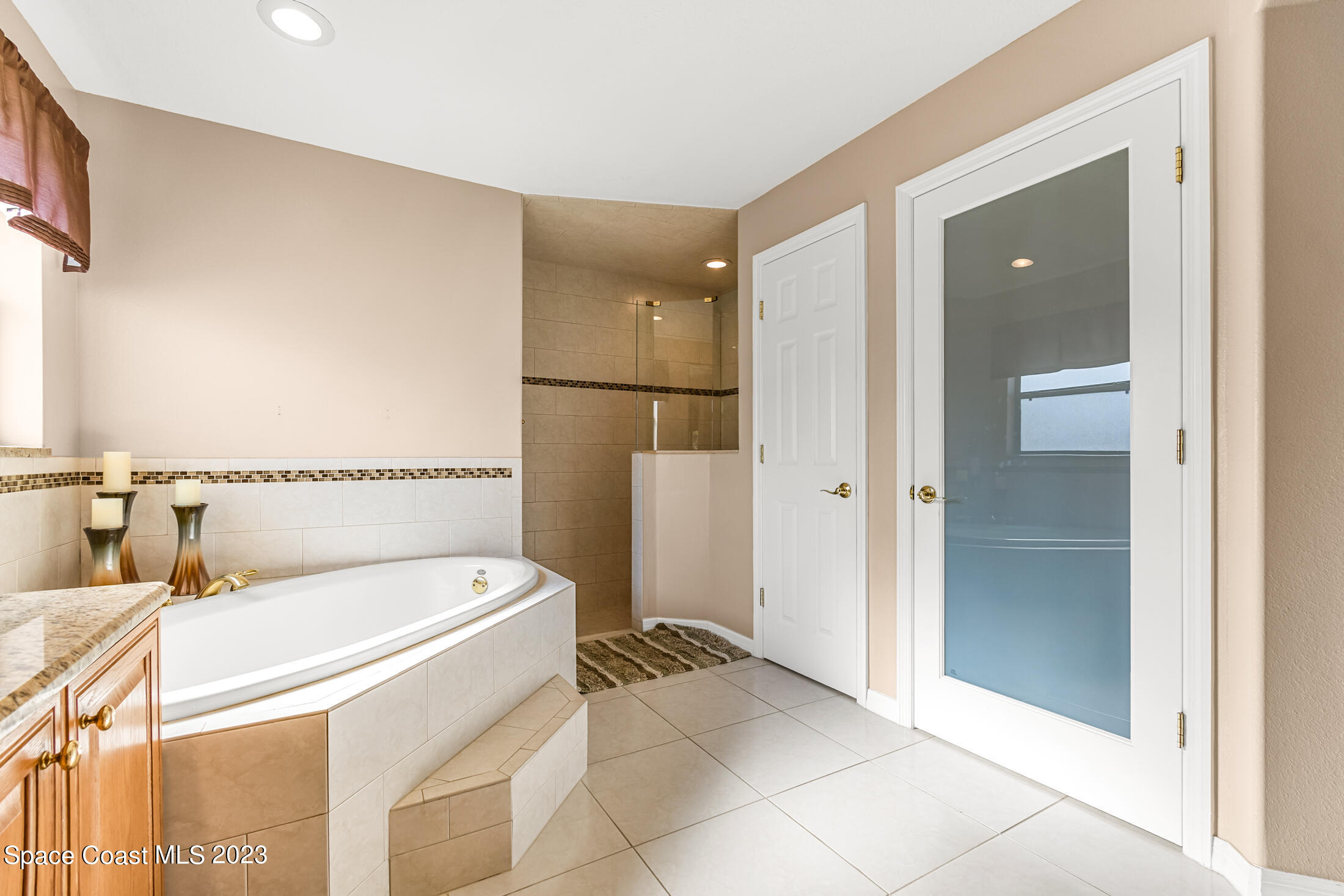 1201 Daton Road Southwest Palm Bay, FL 32908 - Photo 26 of 46 a bathroom with a tub and a shower