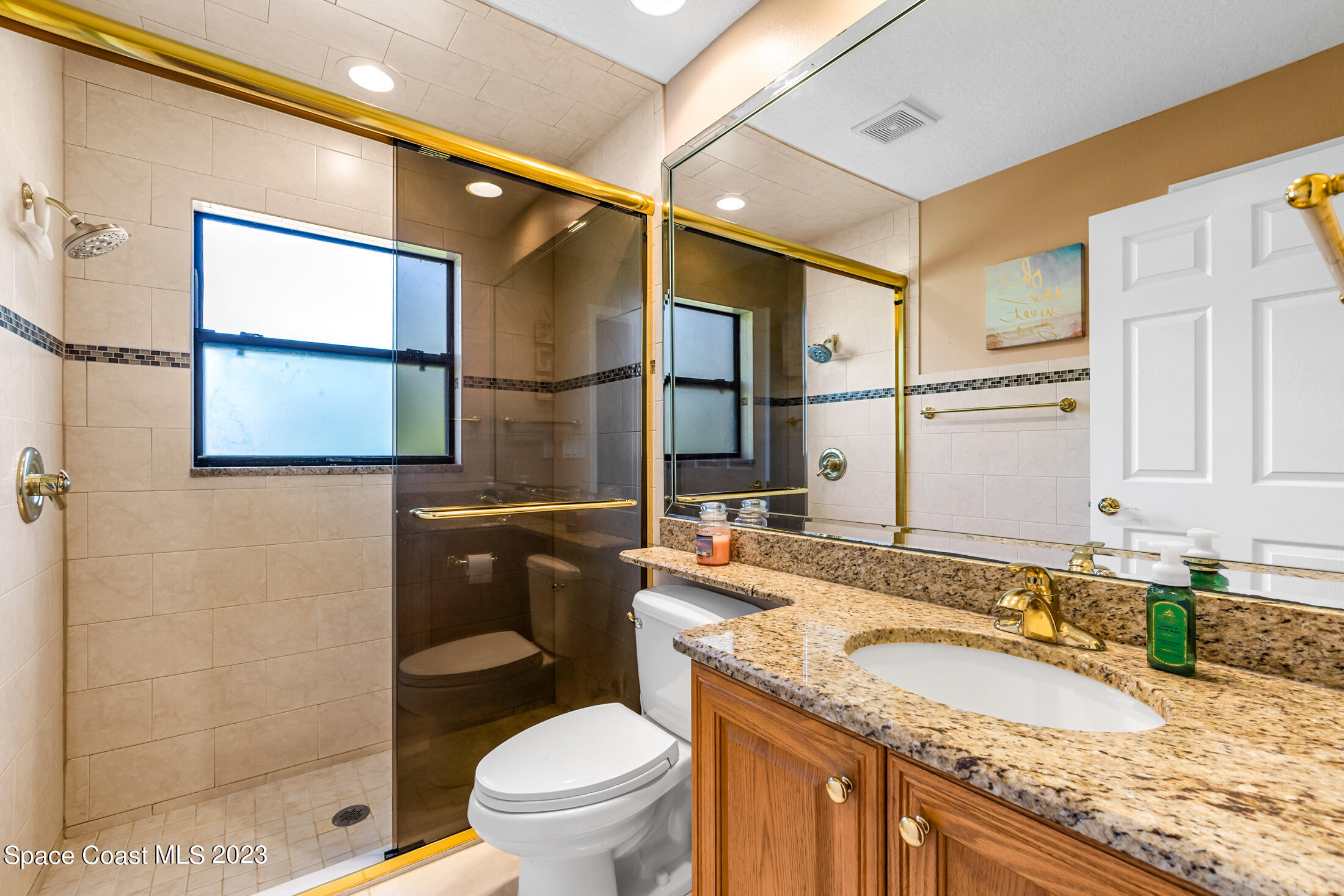 1201 Daton Road Southwest Palm Bay, FL 32908 - Photo 29 of 46 a bathroom with a granite countertop sink toilet and shower