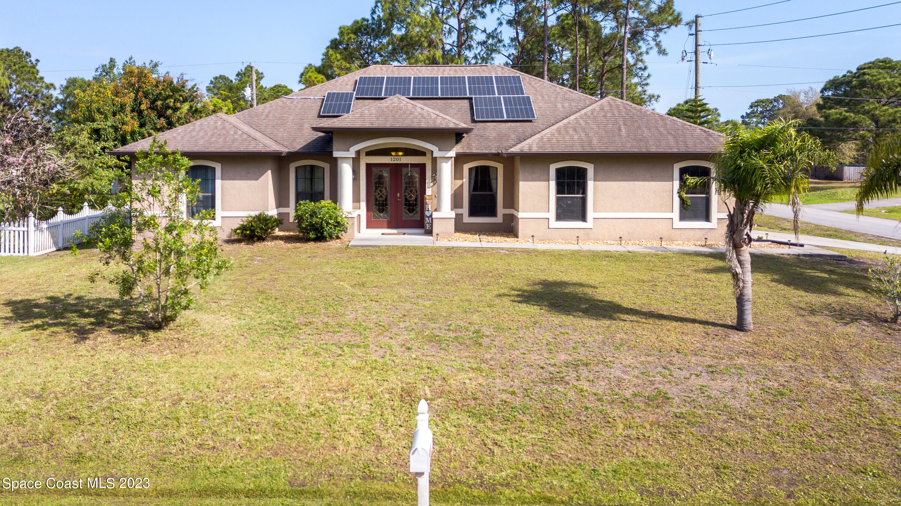 1201 Daton Road Southwest Palm Bay, FL 32908 - Photo 4 of 46 a front view of a house with a yard