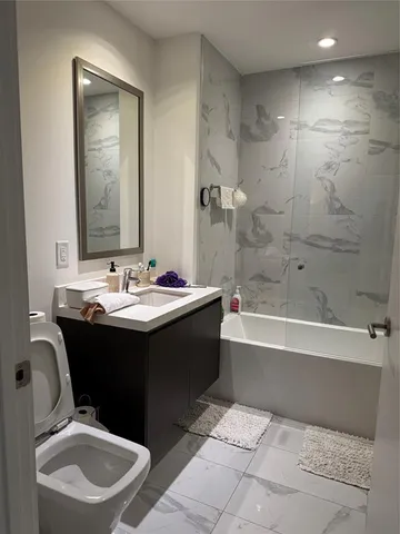 a bathroom with a sink a toilet and bathtub