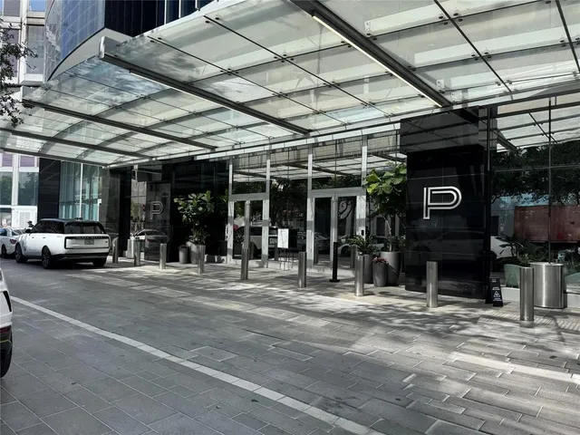 a view of a street with cars parked